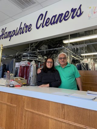 Nereida and Alfred standing at the counter of their cleaners